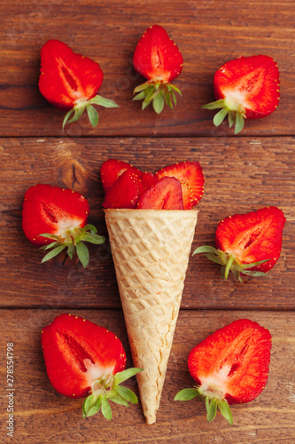 Fototapeta Naklejka Na Ścianę i Meble -  Fresh strawberry in waffle cone. Creative food concept