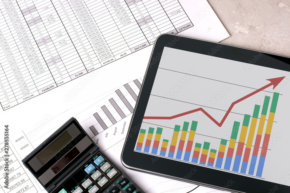 Workplace with tablet and stock charts. Accountant work table Workplace with tablet and stock charts. Accountant work table