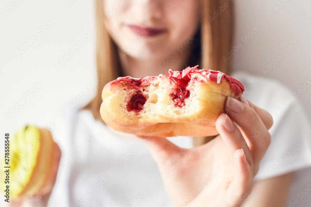 Close up portrait of a girl eating donuts Close up portrait of a girl eating donuts