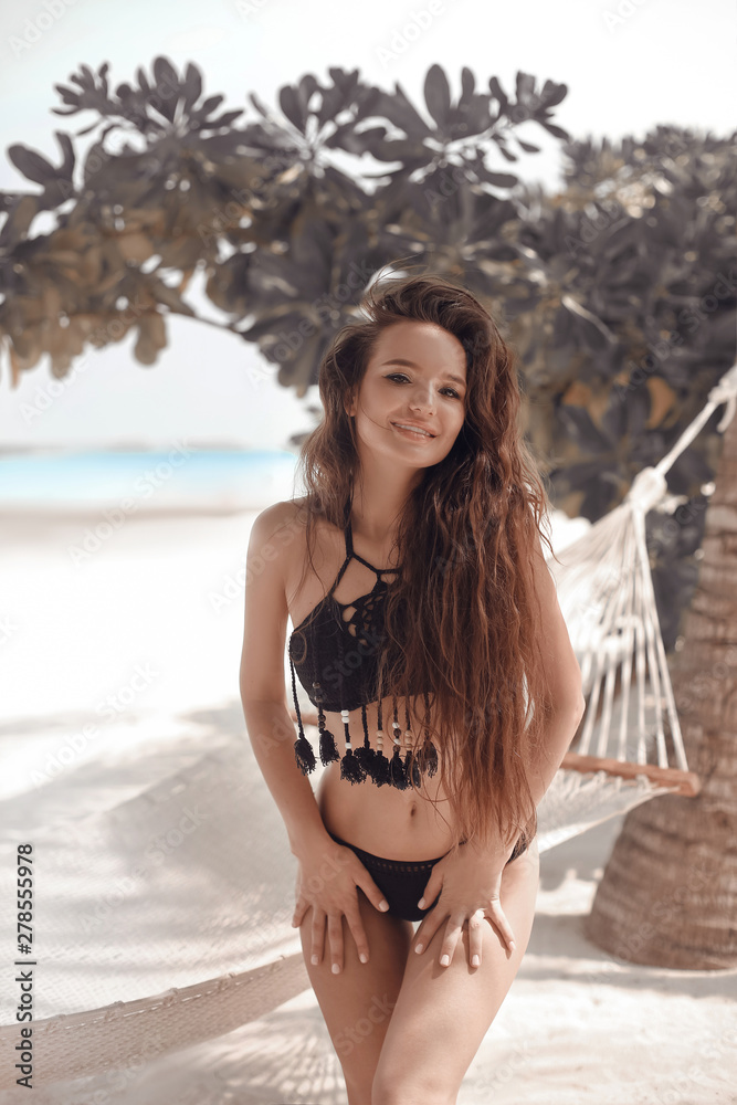 Brunette bikini model in black boho swimwear having fun by hammock on  tropical beach, summer vaction. Free girl with long curly hair enjoying on  exotic island. Photos | Adobe Stock