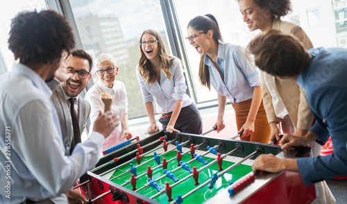 Coworkers playing table football on break from work