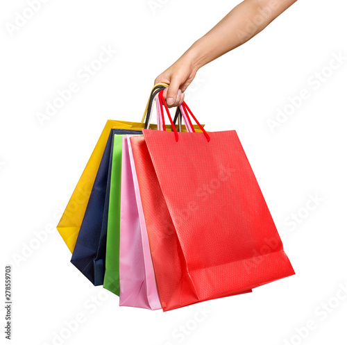 A woman hand carrying a bunch of shopping bags isolated on white