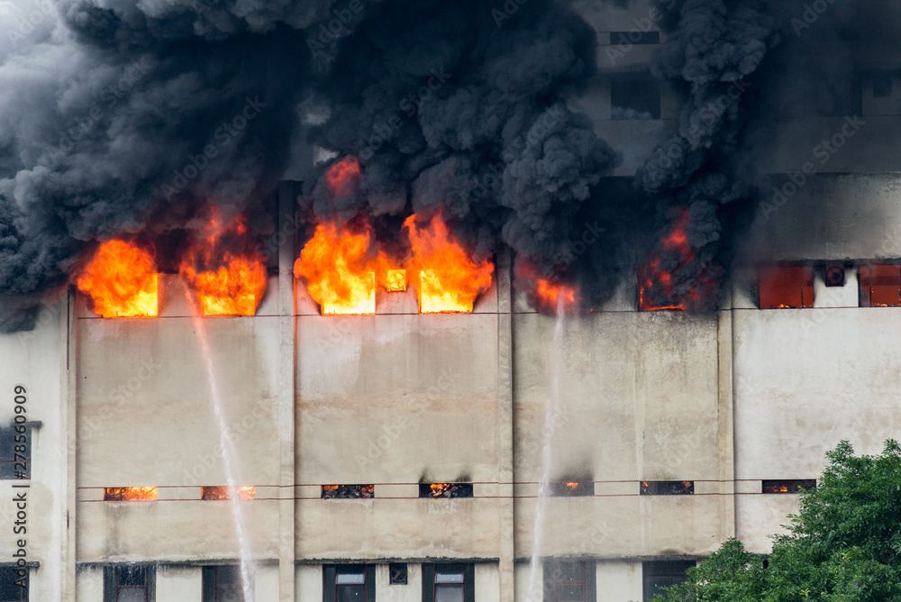 Fototapeta premium A fire broke out in the warehouse and the fire brigade was putting out the fire.