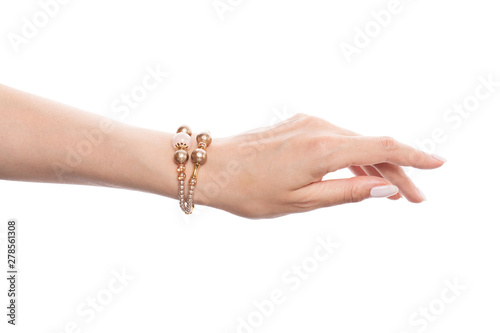 Vászonkép Golden jewelry bracelet with pearls on female hand isolated on white background