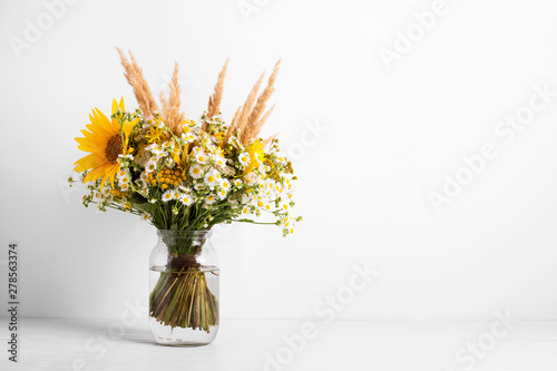 Wallpaper Mural Field flowers in a glass vase. Summer bouquet of flowers on the white background Torontodigital.ca