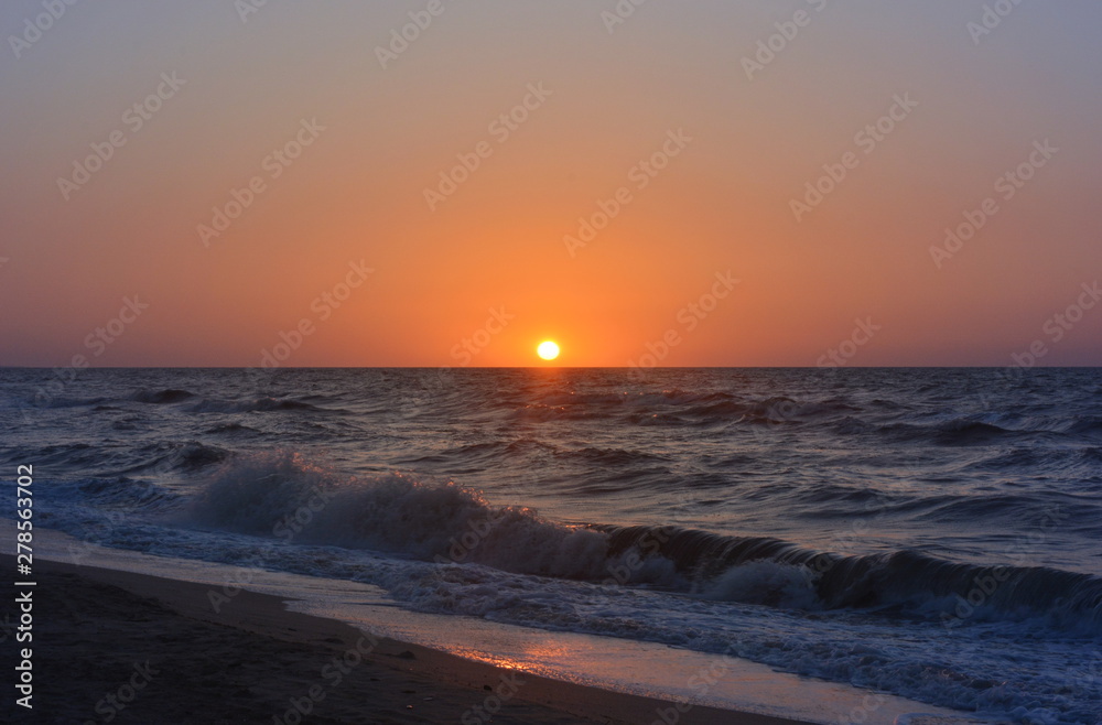 Fototapeta premium Sunset on the sea with cloudless sky