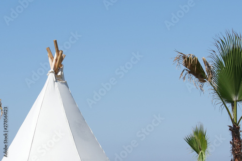 Bungalow on the beach built in the shape of a wigwam. photo