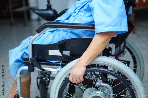 Asian senior or elderly old lady woman patient on electric wheelchair with remote control at nursing hospital ward : healthy strong medical concept 