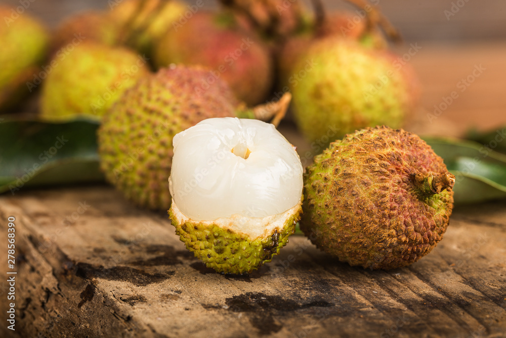 Fresh lychees on a wooden board background Fresh lychees on a wooden board background
