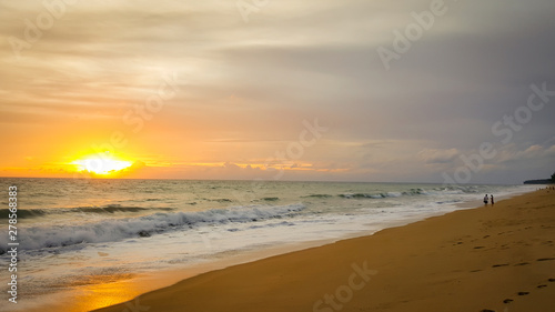 Fototapeta Naklejka Na Ścianę i Meble -  Tropical beach sunset with wave in the sea at Maichao beach in Phuket city, Thailand
