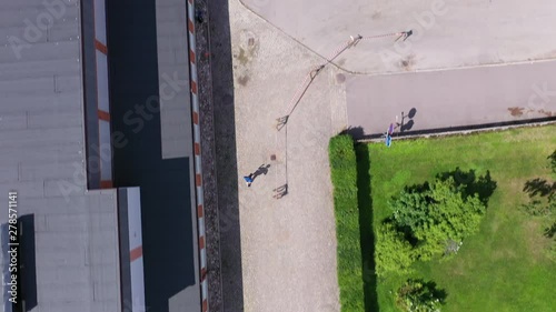 Top-down drone footage following a single athlete running down a street in a residential area. Filmed in realtime. photo