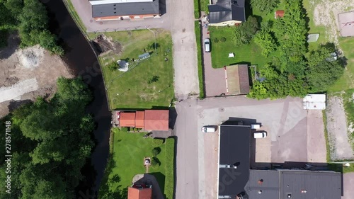 Descending top-down drone footage of a single athlete running down a street in a residential area. Filmed in realtime. photo