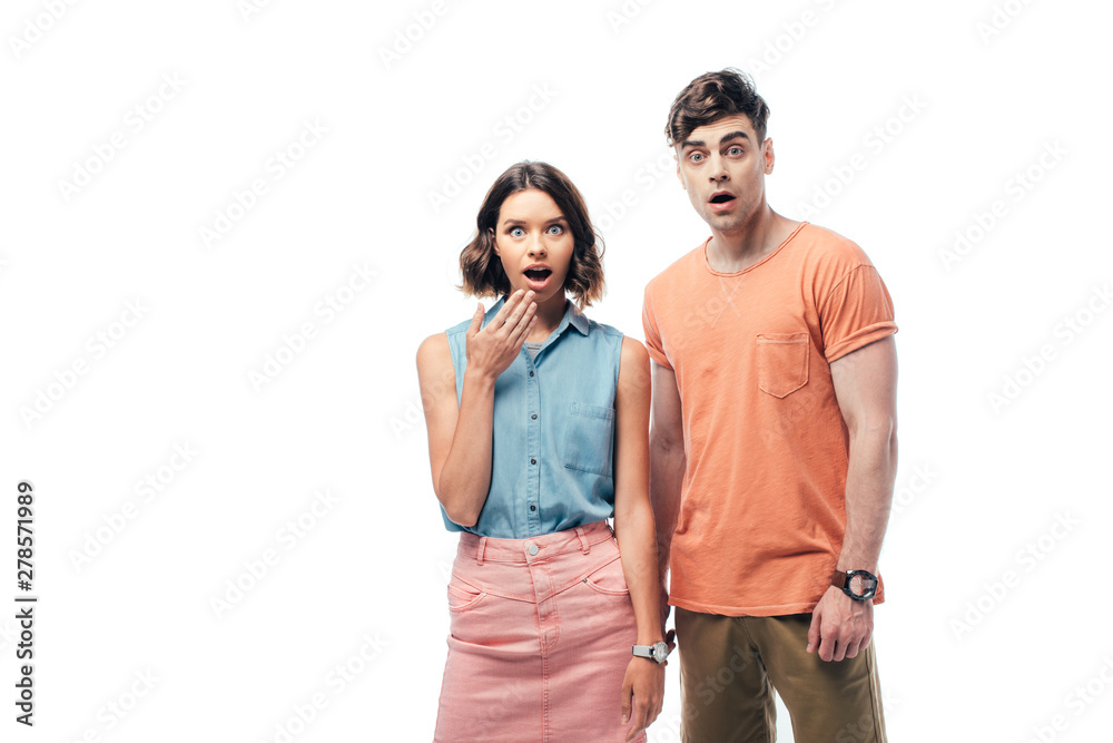 young, surprised man and woman looking at camera isolated on white young, surprised man and woman looking at camera isolated on white