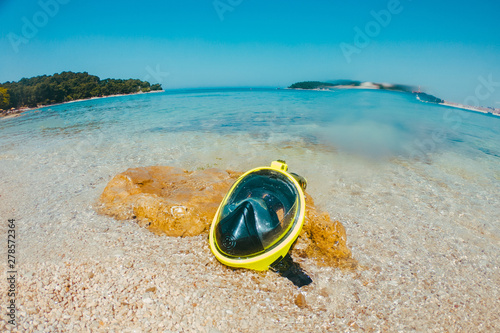yellow snorkeling mask at sea beach close up