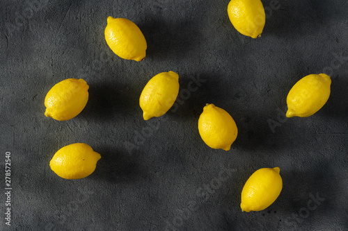 Pile of lemons on a dark background top view