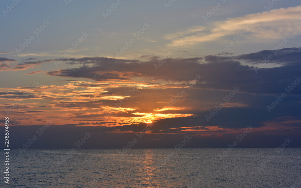 Sunset in the clouds on the sea