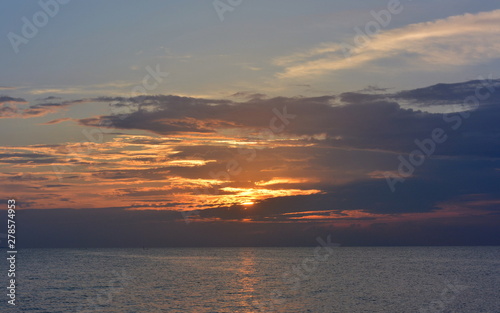 Sunset in the clouds on the sea