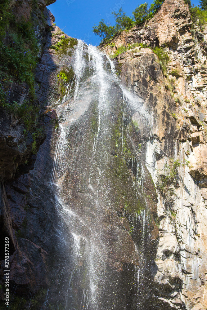 Obraz premium Butakovsky waterfall in the mountains of the city of Almaty, Kazakhstan. Summer in the mountains