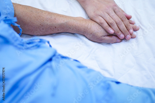 Touching hands Asian senior or elderly old lady woman patient with love, care, helping, encourage and empathy at nursing hospital ward : healthy strong medical concept 