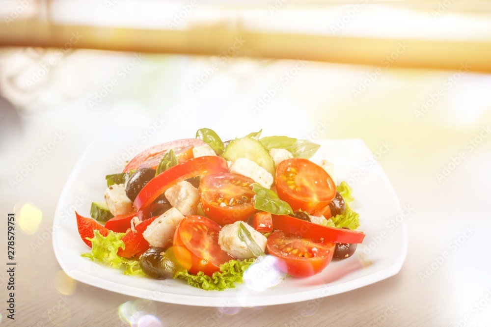 Greek Salad - Feta Cheese, Olive and Vegetables, isolated on white Greek Salad - Feta Cheese, Olive and Vegetables, isolated on white