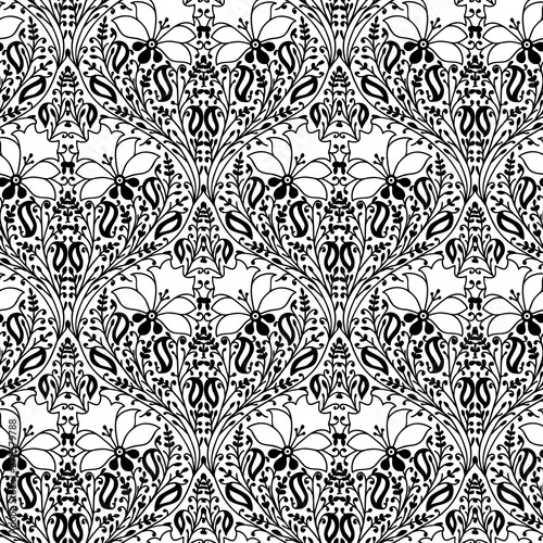 Monochrome woodblock printed seamless ethnic floral pattern. Traditional oriental ornament of India, damask of flowers and leaves, black on white background. Textile design.