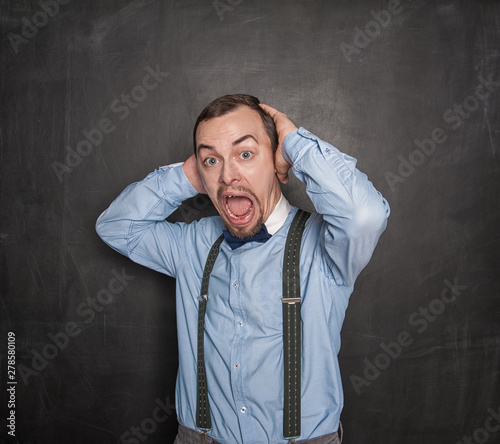 Surprised Funny teacher man on blackboard