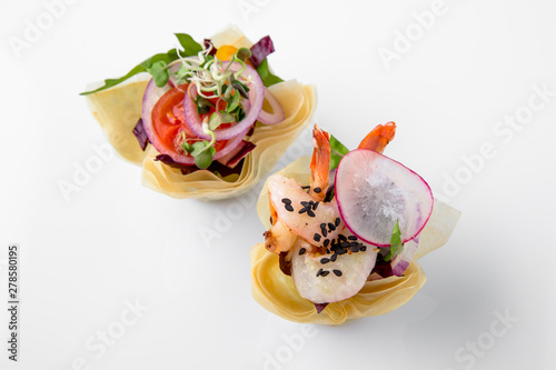 Canape tartlet with shrimp and vegetables. Beautifully decorated catering banquet menu. Food snacks and appetizers for buffet. Isolated on white background photo