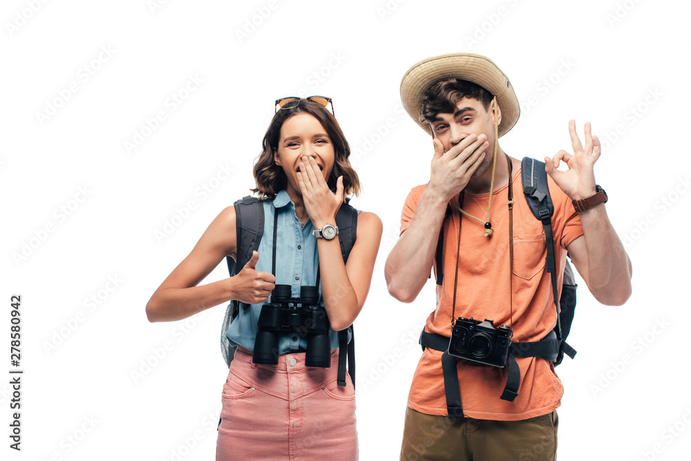two cheerful tourists showing thumb up and ok sign while looking at camera isolated on white two cheerful tourists showing thumb up and ok sign while looking at camera isolated on white