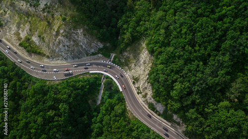 Drones Eye View - winding road from the high mountain pass in Sochi, Russia. Great road trip trough the dense woods. © Quatrox Production