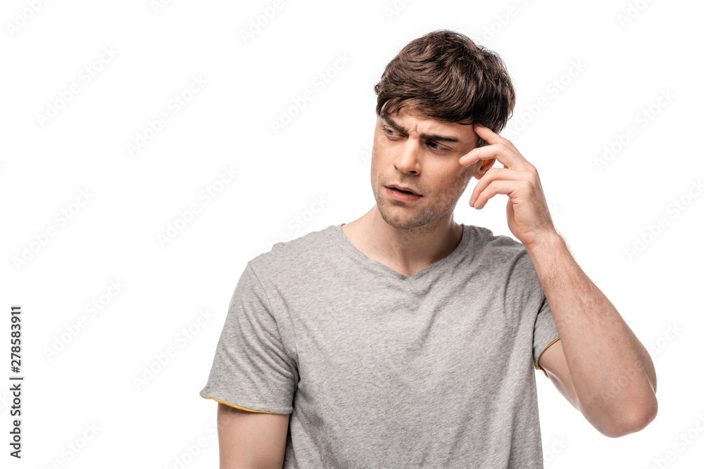 thoughtful young man looking away while holding hand near head isolated on white thoughtful young man looking away while holding hand near head isolated on white