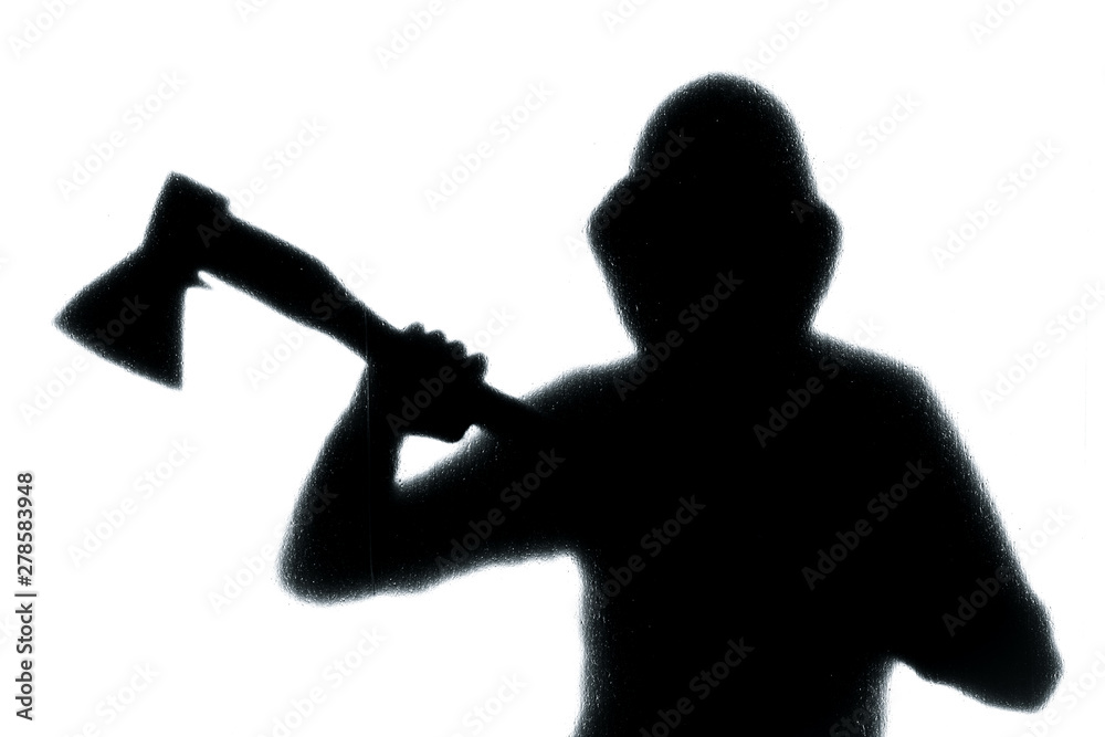 Dangerous man behind frosted glass with an axe in his hand. Halloween. Black and white image. Dangerous man behind frosted glass with an axe in his hand. Halloween. Black and white image.