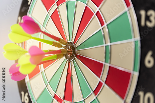 Three arrows hitting on center og dartboard.business goal success concept