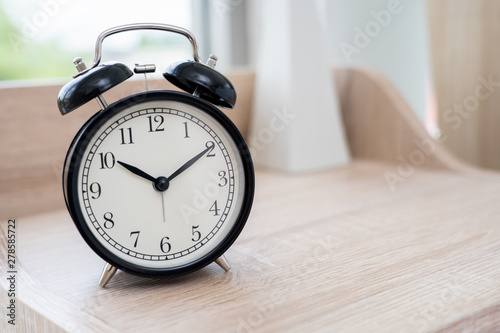 Vintage Black Alarm clock on table in bedroom