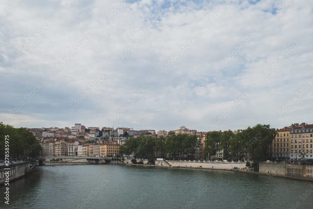 Obraz premium Buildings and bridges over the Saone River in downtown Lyon, France