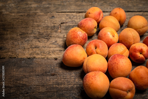 fresh apricots in a basket on a wooden table