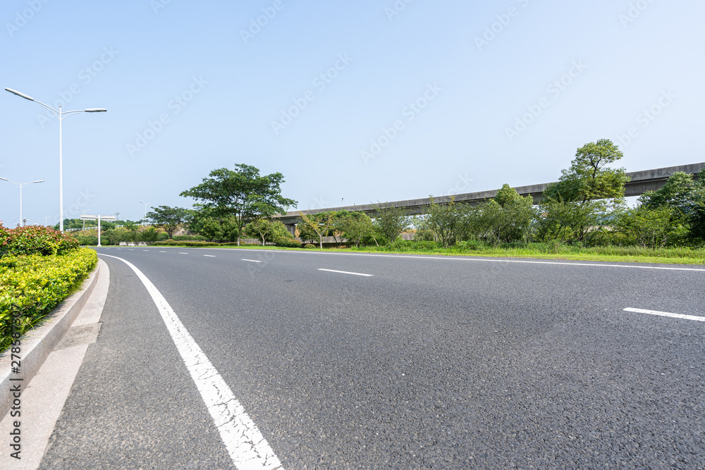 Fototapeta premium empty asphalt road with city skyline