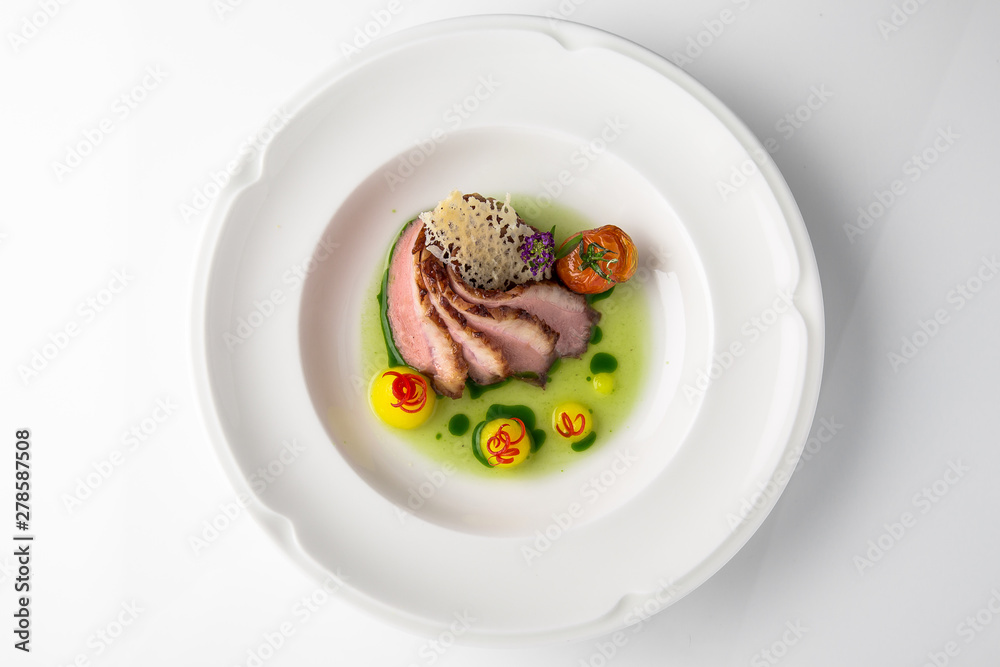 Sliced pork carving in sauce with mashed potatoes and grilled vegetables. Banquet festive dishes. Fine dining restaurant menu. White background. Sliced pork carving in sauce with mashed potatoes and grilled vegetables. Banquet festive dishes. Fine dining restaurant menu. White background.