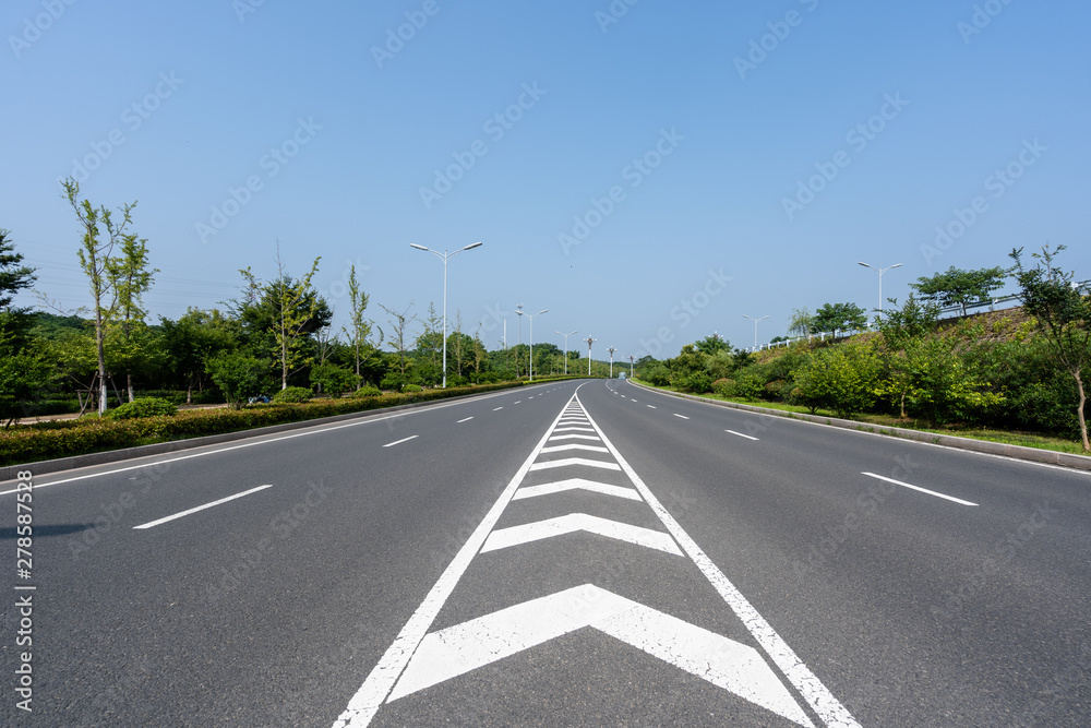 Fototapeta premium empty asphalt road with city skyline