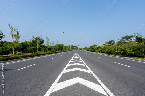 empty asphalt road with city skyline