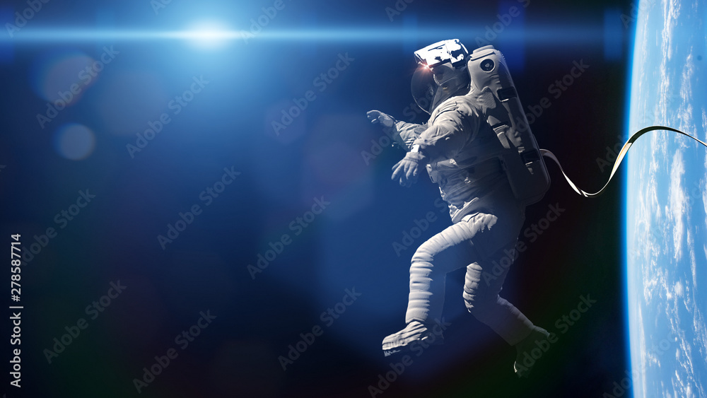 astronaut performing a spacewalk in orbit of planet Earth - obrazy, fototapety, plakaty 