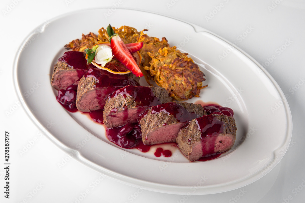Fototapeta premium Filet mignon Beef, or Pork. Grilled young calf tenderloin with berries, mashed potatoes. Banquet festive dishes. Fine dining restaurant menu. White background. 