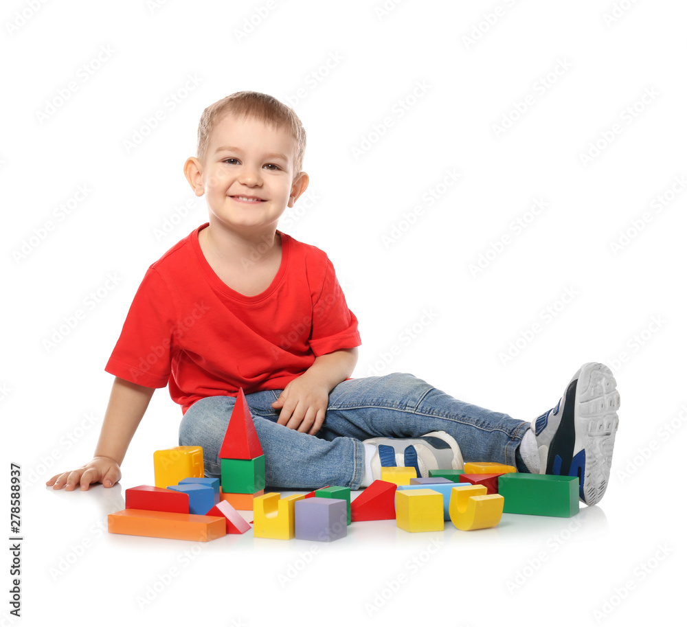 Little child playing with colorful building blocks on white background