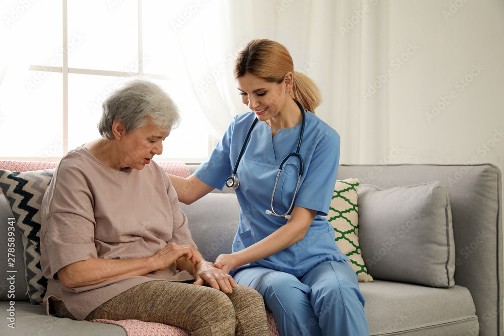 Obraz premium Nurse with elderly woman indoors. Assisting senior people