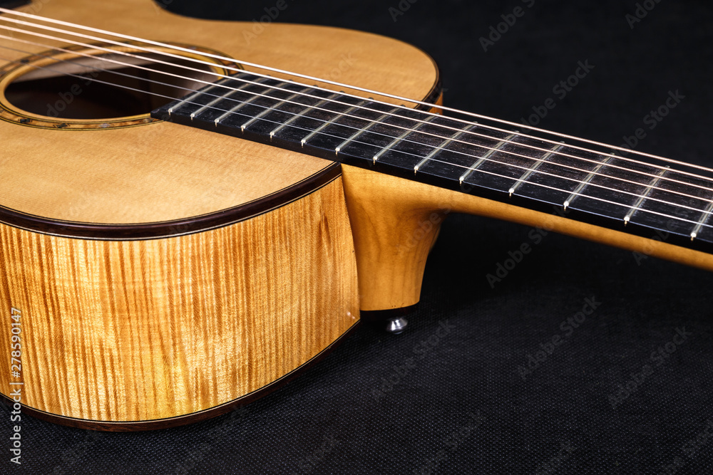 Fototapeta premium Tuning pegs on wooden machine head of six strings acoustic guitar neck on black background