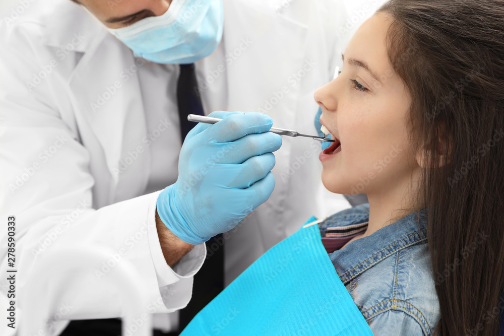 Professional dentist working with little girl in clinic Professional dentist working with little girl in clinic