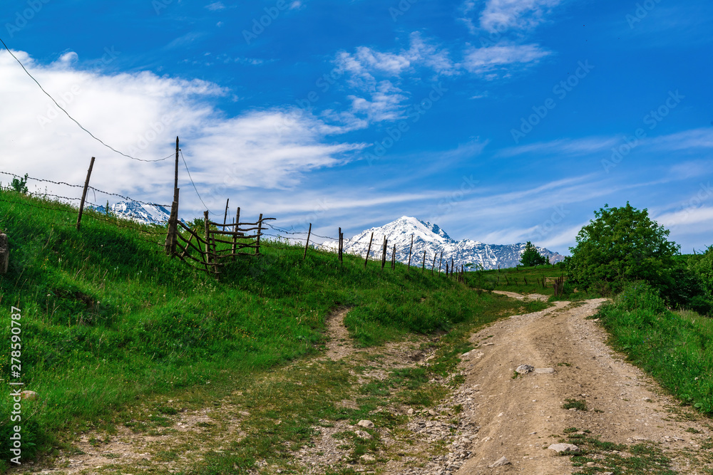 Beautiful view of alpine meadows in the Caucasus mountains. Pastures, meadows on the slopes and snow-capped mountains. Beautiful view of alpine meadows in the Caucasus mountains. Pastures, meadows on the slopes and snow-capped mountains.