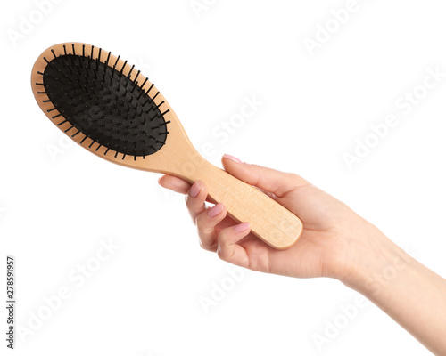 Woman holding wooden hair brush against white background, closeup