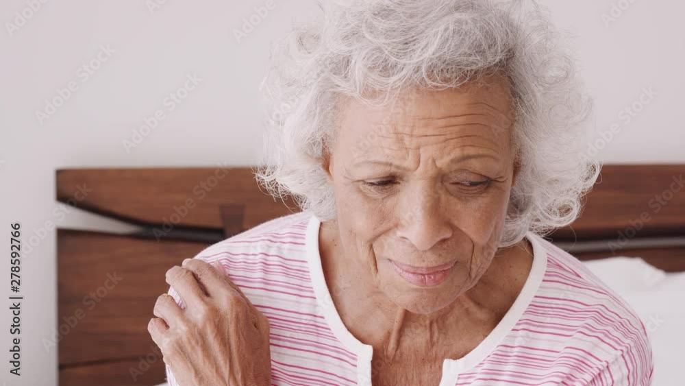 Close Up Of Depressed Senior Woman Looking Unhappy Sitting On Side Of Bed At Home Close Up Of Depressed Senior Woman Looking Unhappy Sitting On Side Of Bed At Home