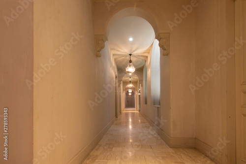 The hotel corridor is decorated in antique style.