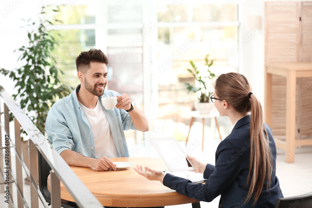 Female insurance agent working with client in office Female insurance agent working with client in office